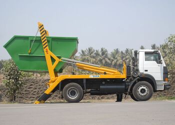 Skip Lorry with skip in process of being loaded on the lorry, all rights reserved Tata Motors